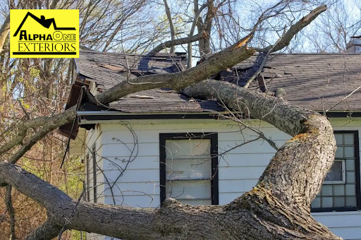 Tree fallen on residential roof after storm damage in Dayton Ohio
