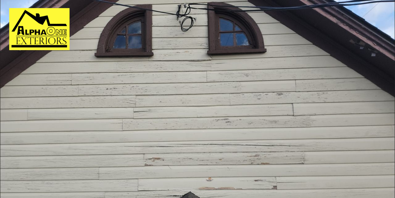 Peeling and flaking exterior paint on wood siding of older home in Dayton, Ohio.