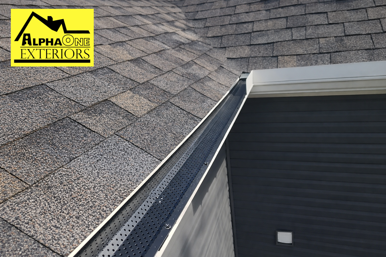 Black aluminum gutter guard installed on asphalt shingle roof in Dayton, Ohio