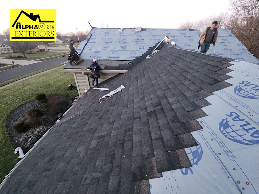 Roofing crew installing architectural shingles and underlayment during roof replacement project in Dayton, Ohio.