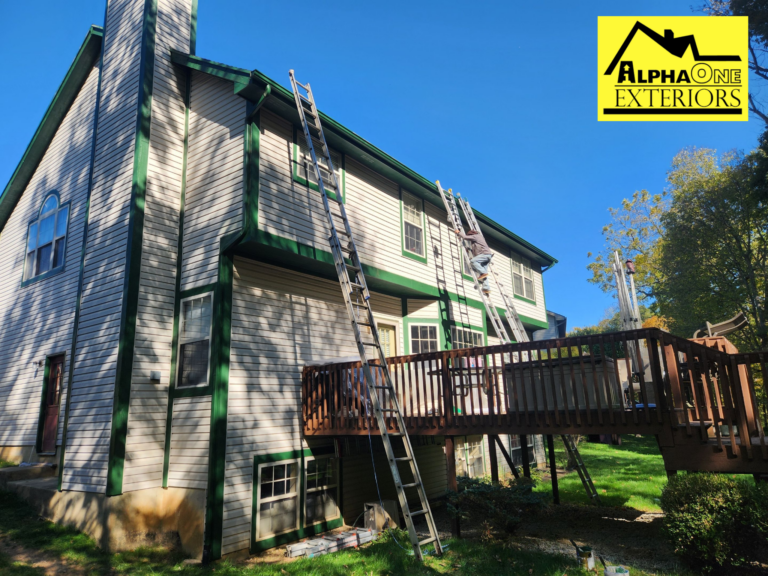 Painter on a lift applying trim paint to a two-story home in Vandalia, Ohio