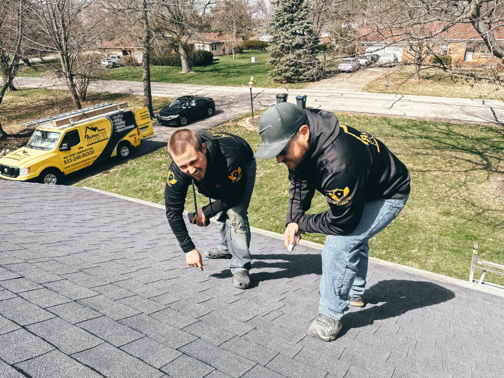 Roofing contractor performing roof inspection in Dayton Ohio assessing condition and potential damage