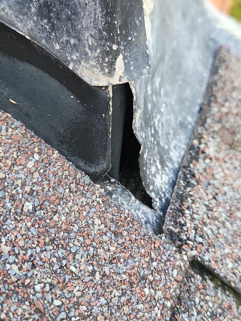 Chimney flashing inspection in Kettering Ohio showing gap and potential water intrusion point near roofline
