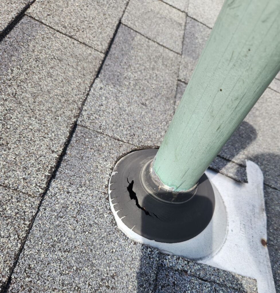 Damaged pipe flashing in Kettering Ohio showing cracked rubber boot and potential roof leak around vent pipe