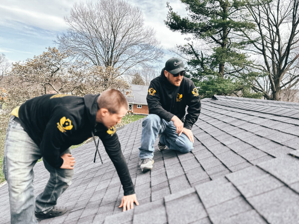 Roof inspection in Kettering Ohio with contractors examining asphalt shingles for damage and wear