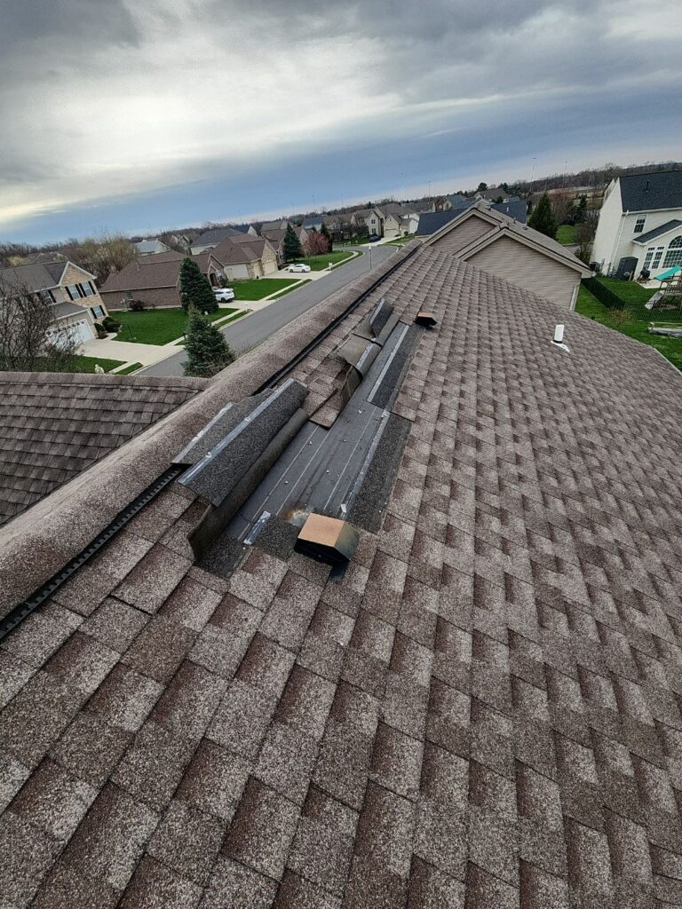 Roof storm damage in Vandalia Ohio showing missing shingles from high winds