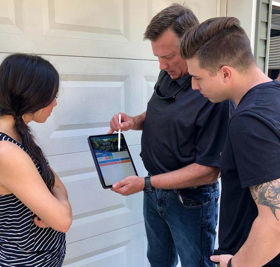 Roofing contractor reviewing roof inspection results with homeowner in Dayton Ohio