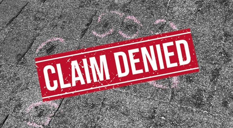 Denied roof insurance claim in Ohio showing hail damage impacts on asphalt shingles after a storm inspection