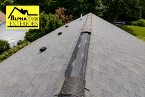 Missing ridge cap shingles exposing the ridge vent on an asphalt shingle roof in Englewood, Ohio after wind damage.