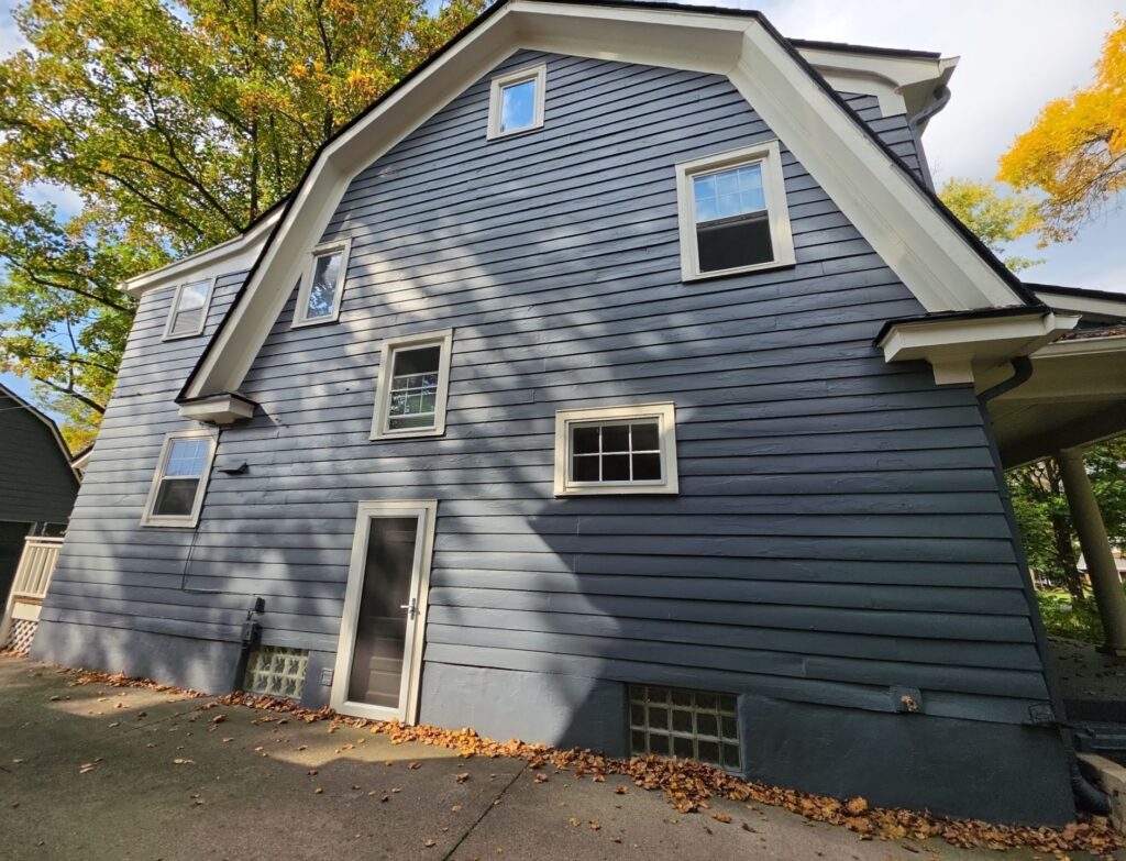 Blue-gray painted wood siding with white trim on a multi-story home in Oakwood, Ohio