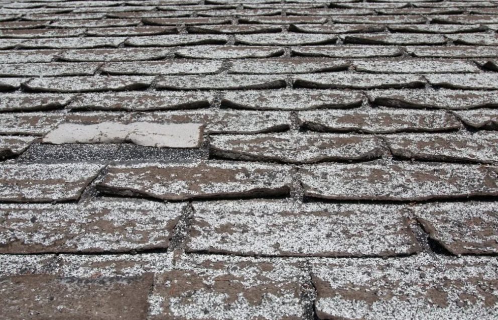 Severely curling asphalt shingles showing roof deterioration in Dayton Ohio