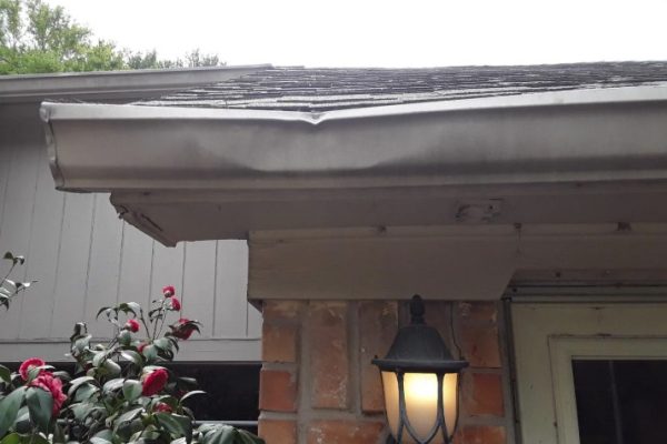 Dented aluminum gutter caused by storm damage on a residential home in Dayton, Ohio