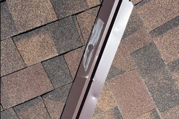 Hail damage dents on roof valley metal identified during a professional roof inspection in Beavercreek, Ohio.
