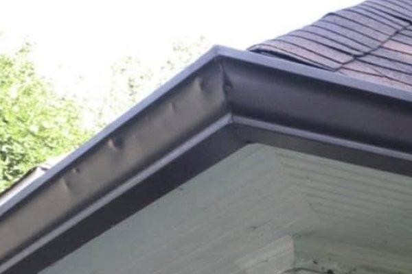 Hail dents visible on an aluminum gutter in Miamisburg, Ohio