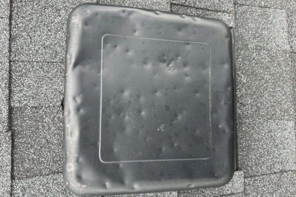 Hail damage dents on a roof exhaust vent identified during a professional roof inspection in Dayton, Ohio.