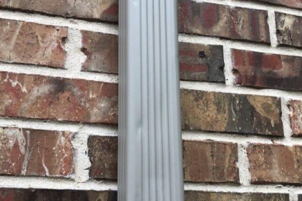 Hail dents visible on an aluminum downspout in Miamisburg, Ohio