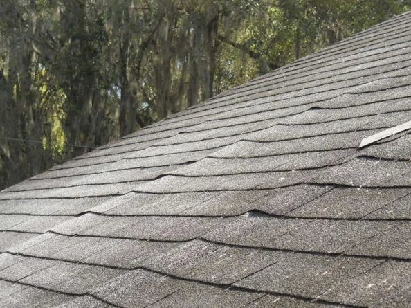 Sagging asphalt shingle roof indicating structural roof damage on Dayton Ohio home