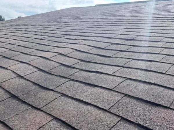 Sagging roof area in Dayton Ohio showing uneven asphalt shingles and potential structural roof issue